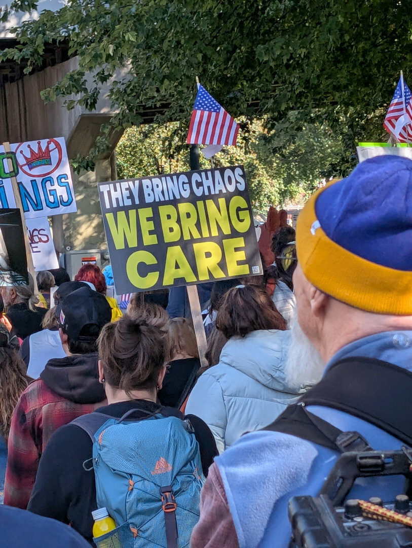 Protest sign reading We Bring Care