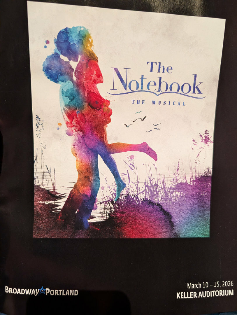 Auto-generated description: A vibrant, colorful poster for The Notebook: The Musical features a silhouette of a couple embracing against a watercolor background, with details about a performance at Keller Auditorium in March 2026.