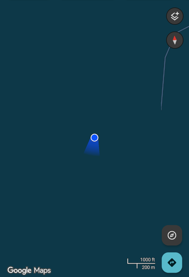 Auto-generated description: A blue location dot is shown on a dark map interface, with a compass icon and distance scale visible.